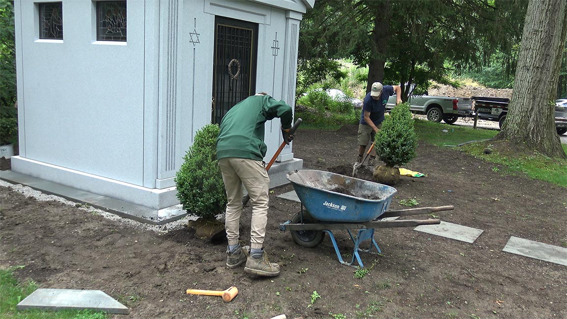 How A Mausoleum Plot Is Landscaped With Trees & Benches