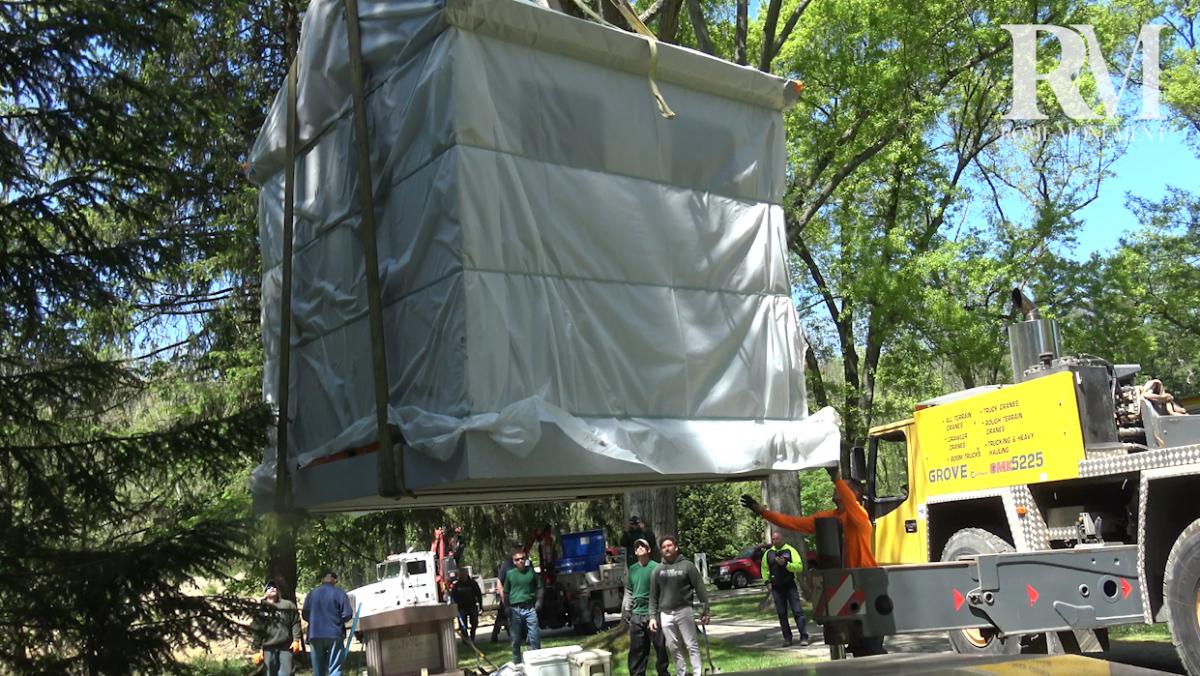 See a Crane Truck Hoist the Mausoleum Onto Its Pad